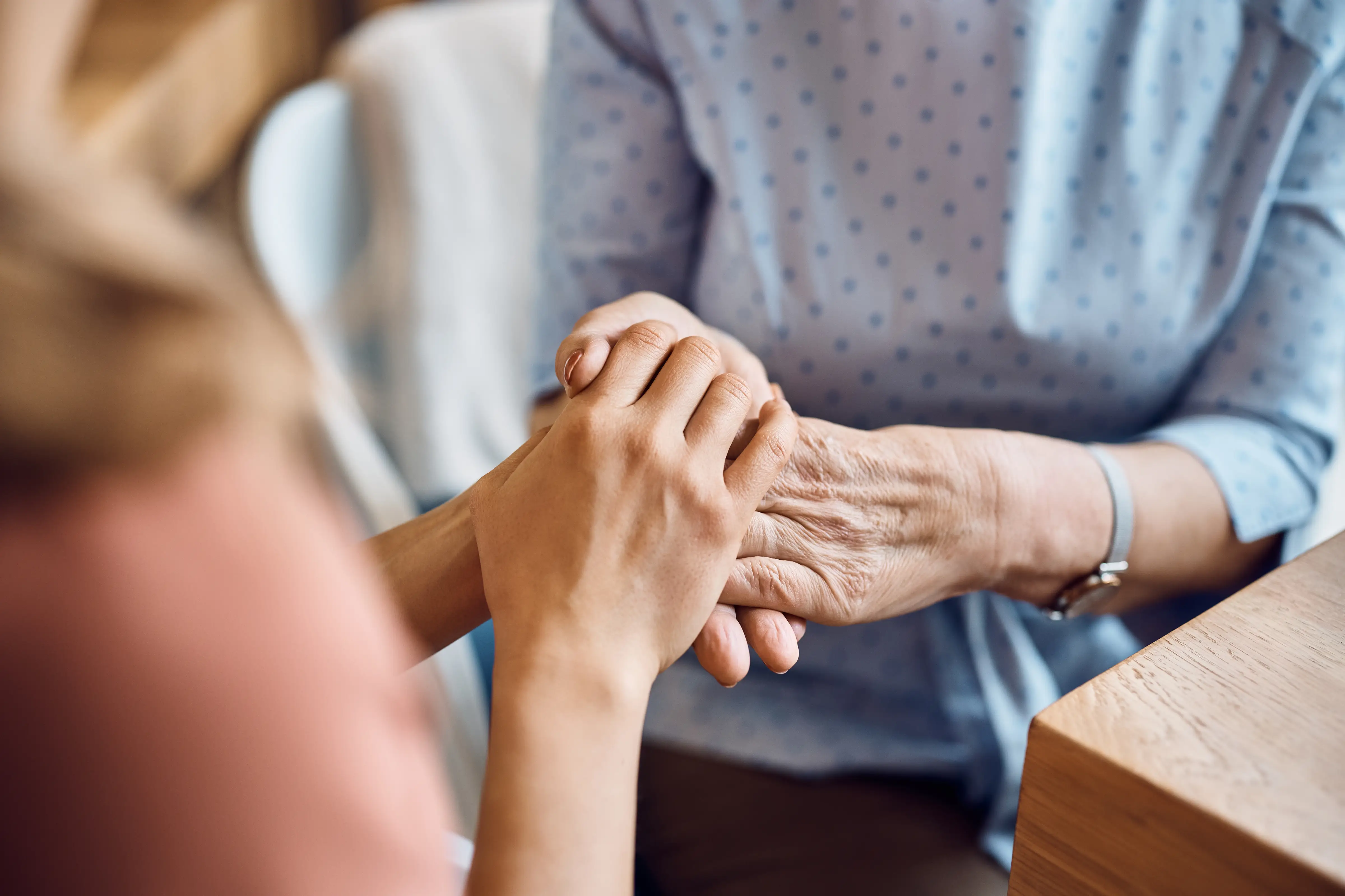 patient holding hands